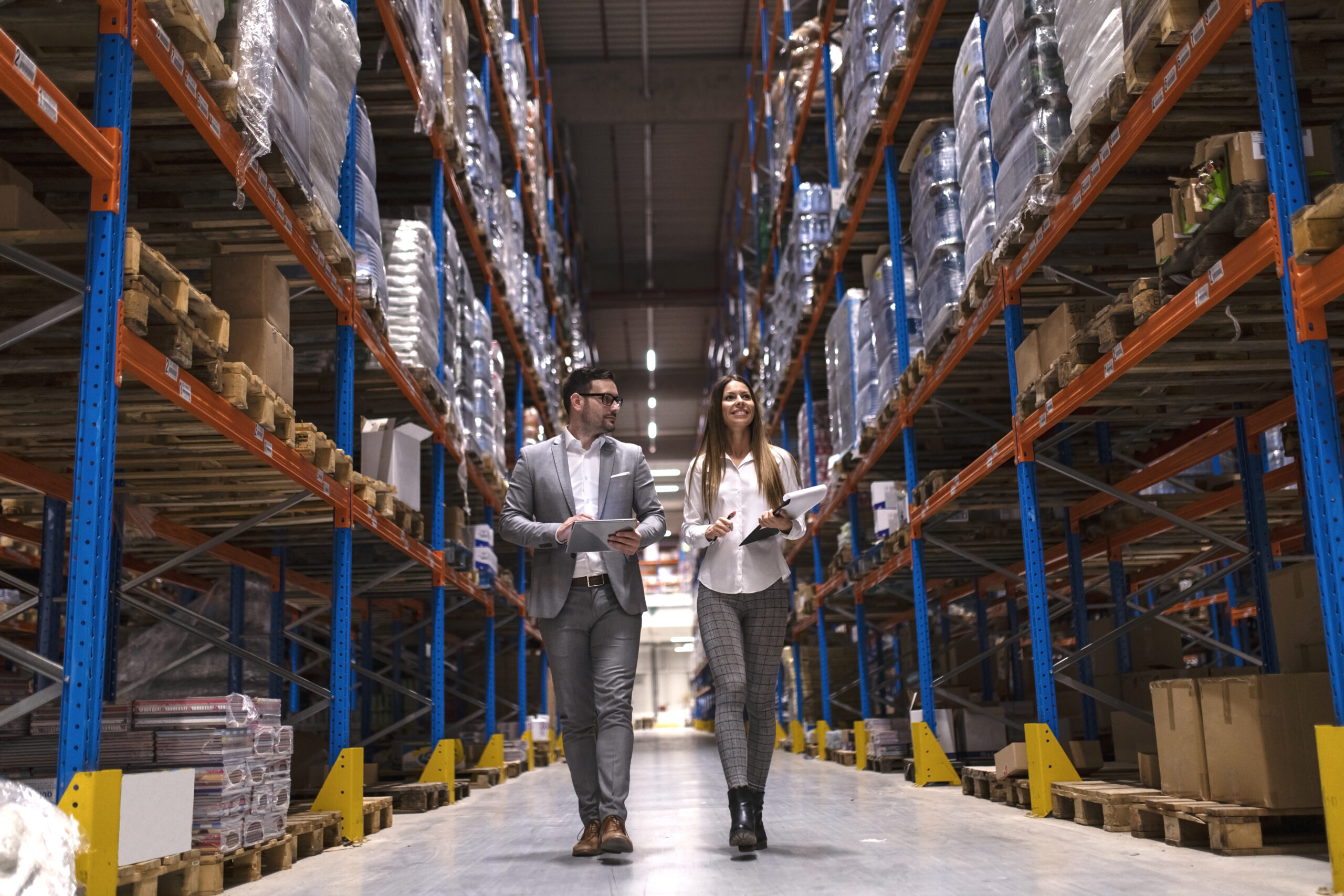 Warehouse managers walking through large distribution center